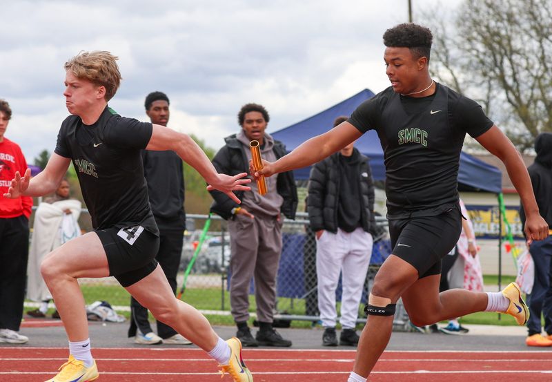Vince Harris hands the baton to St. Mary Catholic Central teammate Brady Rienhard in the boys 400-meter relay 61st annual Mason Track and Field Invitational on Saturday, May 2, 2026.