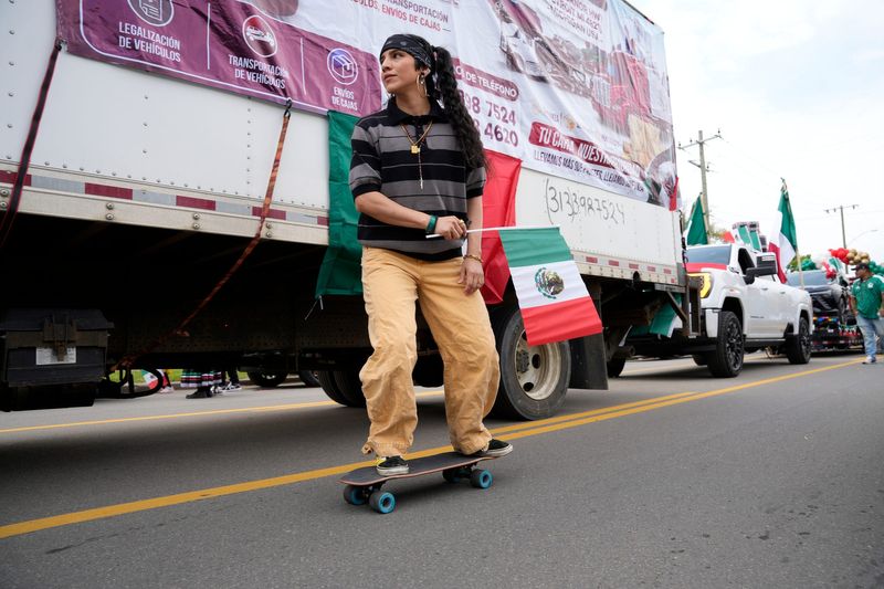 Chris “Poppet” Abolio-Cisneros skateboards through the row of parked parade floats before the Cinco de Mayo Parade in southwest Detroit on Sunday, May 3, 2026.