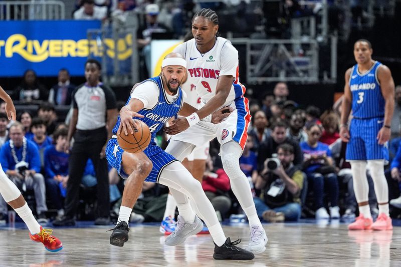 Detroit Pistons guard Ausar Thompson (9) defends Orlando Magic guard Jalen Suggs (4) during the first half of Game 7 of first round of NBA playoffs at Little Caesars Arena in Detroit on Sunday, May 3, 2026.