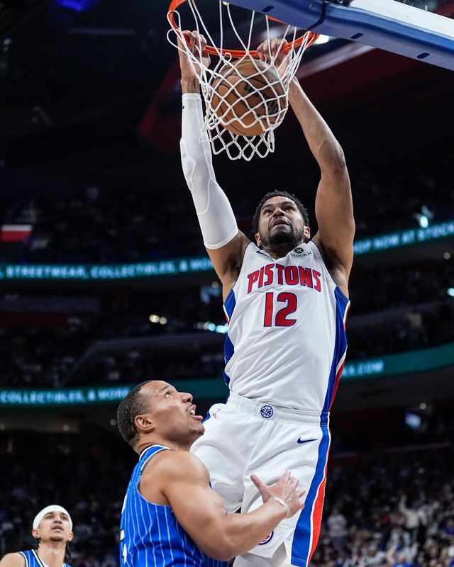 Detroit Pistons forward Tobias Harris (12) dunks against Orlando Magic guard Desmond Bane (3) during the first half of Game 7 of first round of NBA playoffs at Little Caesars Arena in Detroit on Sunday, May 3, 2026.