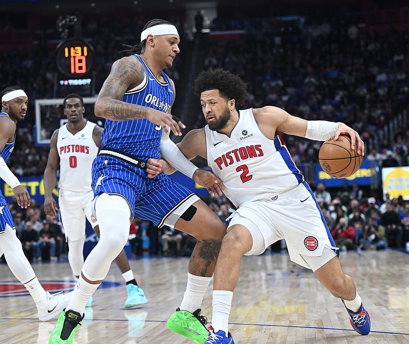 Detroit Pistons guard Cade Cunningham (2) drives past Orlando Magic forward Paolo Banchero (5) in the first half of Game 7 at Little Caesars Arena on Sunday, May 3, 2026, in Detroit.