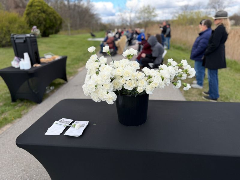 White carnations rest at the base of the newly dedicated memorial in Section AA on May 2, 2026, at Lakeside Cemetery in Port Huron.