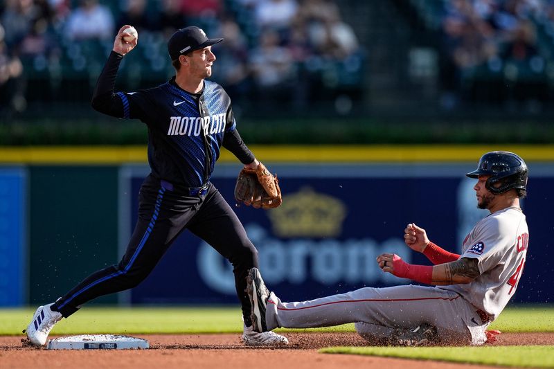 Detroit Tigers shortstop Zack Short (15) throws towards first base as Boston Red Sox first baseman Willson Contreras (40) is out on second base during the first inning at Comerica Park in Detroit on Monday, May 4, 2026.