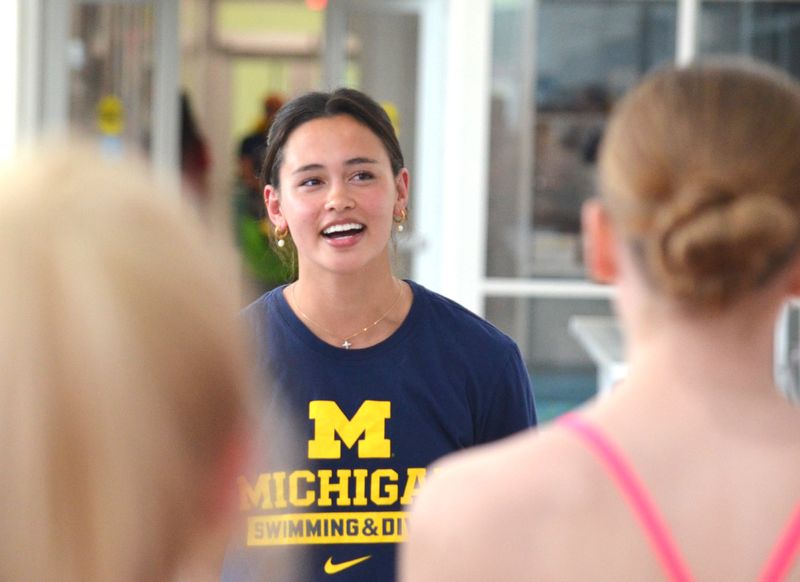 Olympic swimmer Bella Sims talks to Michigan Lakeshore Aquatics swimmers during a clinic on Monday, May 4, at Holland Aquatic Center.