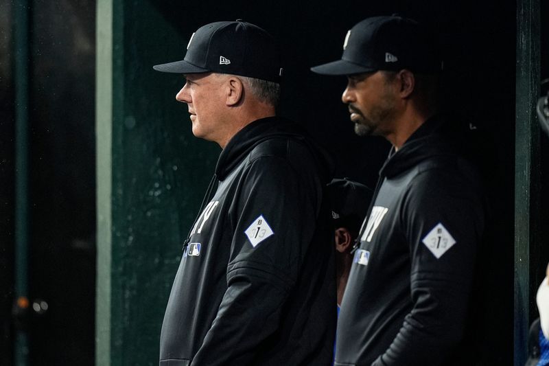 Detroit Tigers manager A.J. Hinch (14), left, and bench coach George Lombard (26) watch a play from the dugout during the sixth inning at Comerica Park in Detroit on Monday, May 4, 2026.