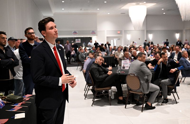 Robert Lulgjuraj, Republican candidate in the 10th Congressional District, listens to a speaker during his campaign event on May 4 at Palazzo Grande in Shelby Township.