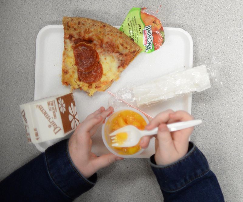 Children at Keith Elementary School eat lunch in the cafeteria where a program called Invisible Dad, is in place. The school lunch program raises money to pay for a child's lunch who has no money their account. Thursday, September 28, 2017. (Photo by Viviana Pernot/ Special to Detroit News)
