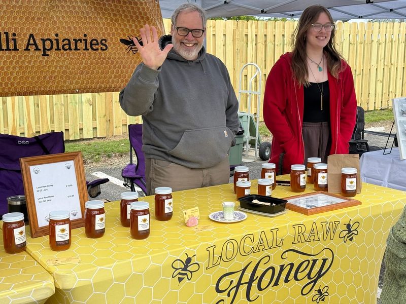 Michael Nardelli, owner of Nardelli Apiaries, with honey for sale at the South Lyon Farmers & Artisans Market on May 2, 2026. The market is open 9 a.m. to 2 p.m. on Saturdays through October downtown.