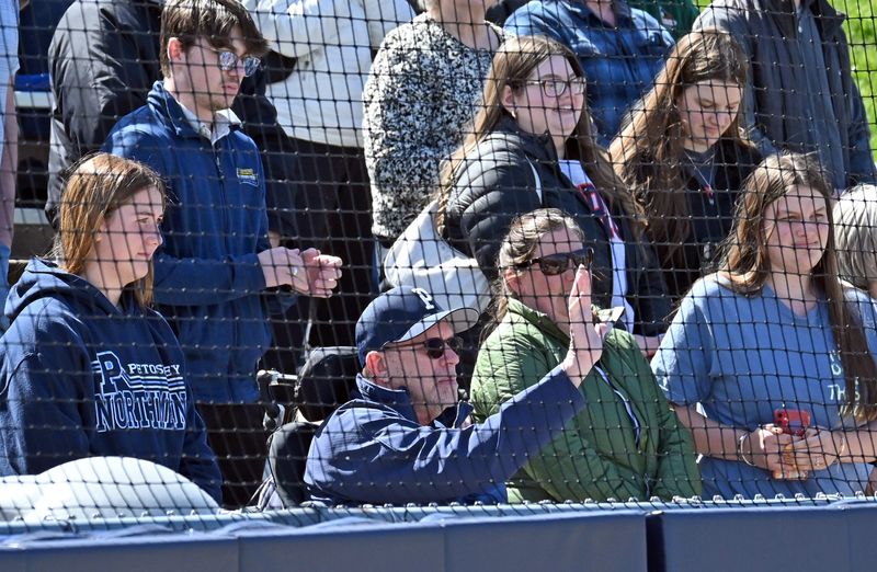 Longtime Petoskey administrator, coach and Northmen fan Brent Hewitt waves to the crowd and his family on Turcott Field before the start of Tuesday's baseball game in Petoskey.