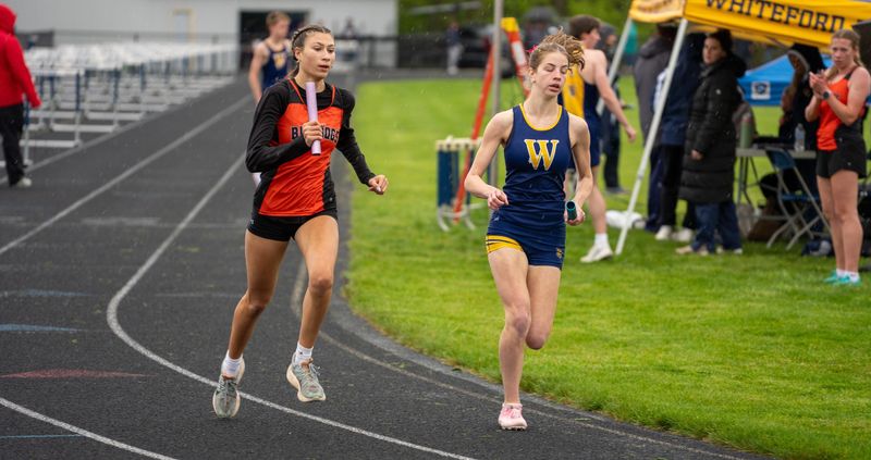 Abby Raymond of Summerfield (left) chases Sierra DeBarr of Whiteford in the 3,200 relay during a 75-62 Summerfield victory on Tuesday, May 5, 2026.