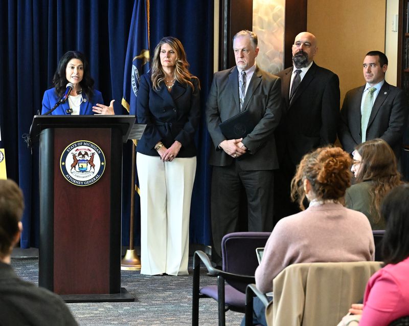 Attorney General Dana Nessel details the criminal charges against Oakland County businesswoman Fay Beydoun on Wednesday alongside her office's criminal justice chief Danielle Hagaman Clark, financial crimes division chief Scott Teter, Assistant Attorney General Matt Payok and deputy chief of investigations Sam Miller at a press conference in the attorney general's office in Lansing.