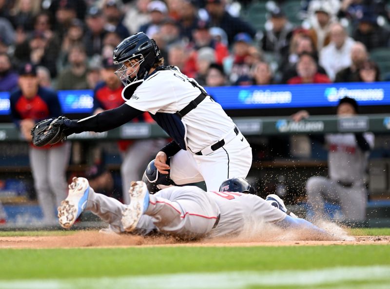 Boston’s Carlos Narváez slides safely in to score before Tigers catcher Dillon Dingler can tag in the third inning. Detroit Tigers take on the Boston Red Sox on May 6, 2026 at Comerica Park in Detroit.