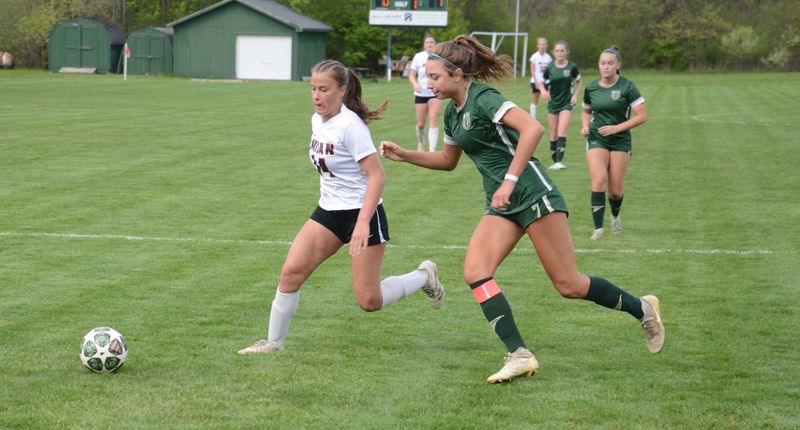 Molly Walline of Milan tries to get past Mary Catholic Central's Quinn Harrington during a 4-0 Milan win in a Huron League round-robin game on Wednesday, May 6, 2026.