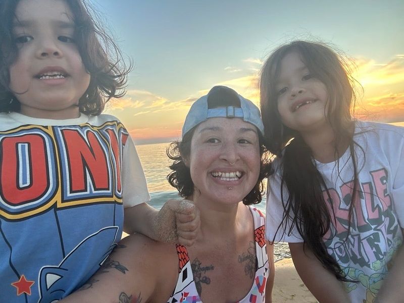 Vilma Escamilla Duran with her twins, now 6-years-old, at the beach in 2025.