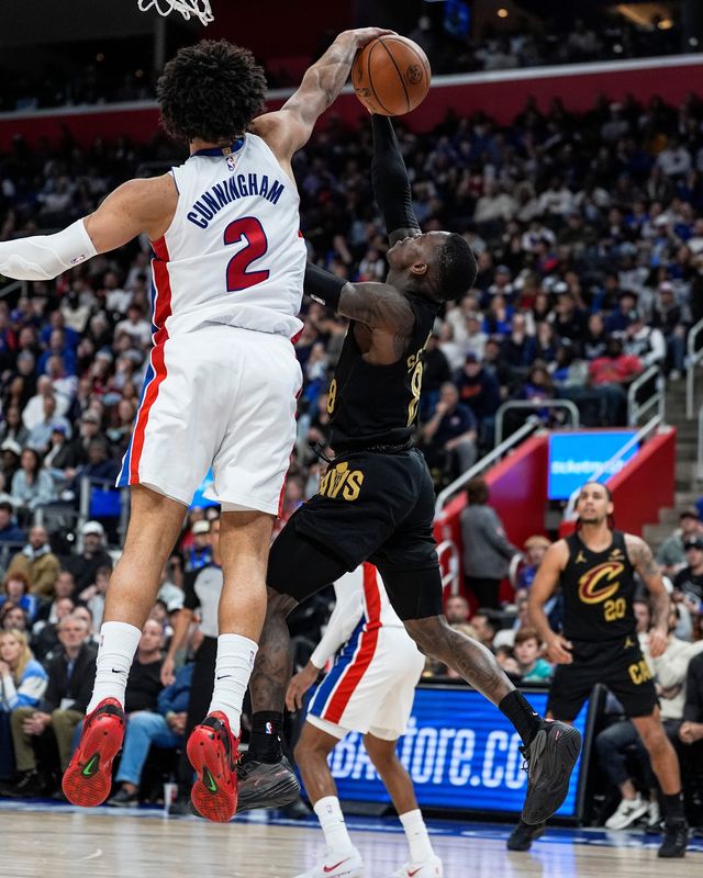 Detroit Pistons guard Cade Cunningham (2) blocks Cleveland Cavaliers guard Dennis Schroder (8) during the second half of Game 2 of second round of NBA playoffs at Little Caesars Arena in Detroit on Thursday, May 7, 2026.