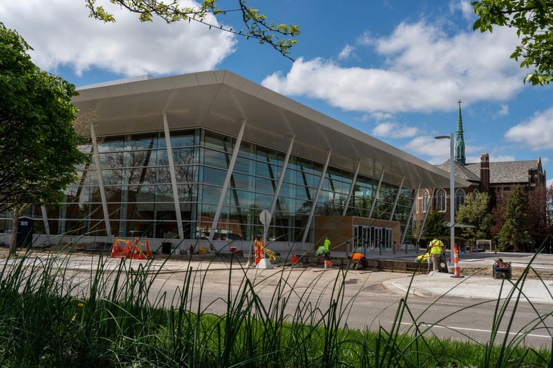 Construction crews work outside the Schaap Center during a tour of the facility in Grosse Pointe Park on Tuesday, April 28, 2026. The $50 million performing arts venue is expected to open in May following multiple delays.