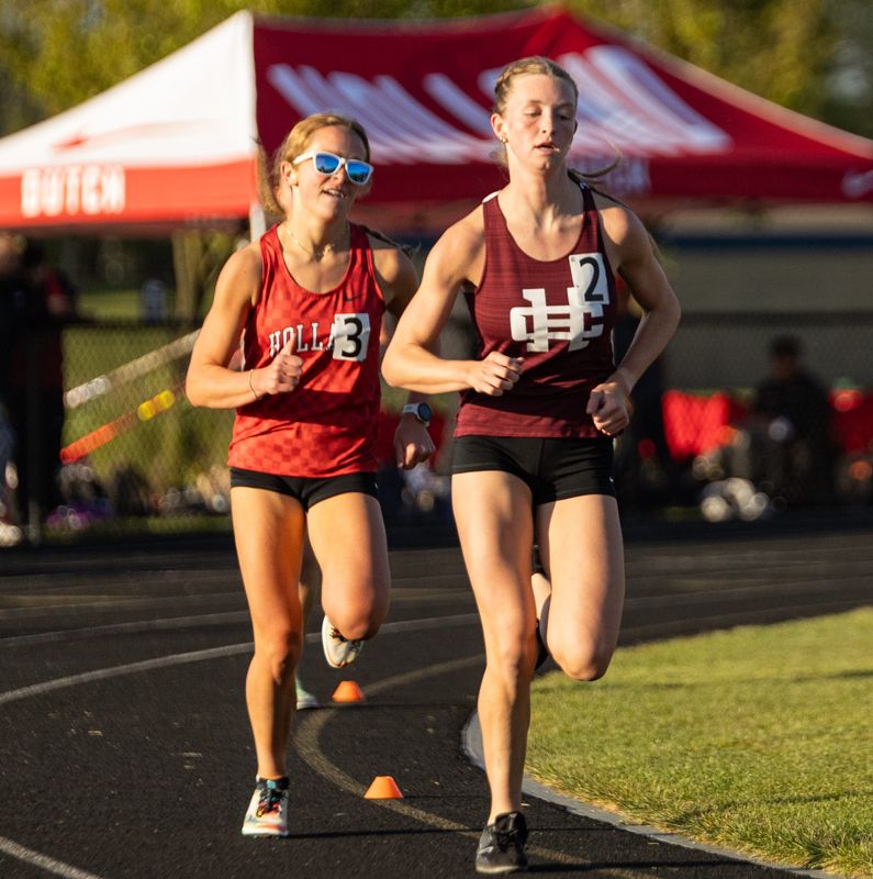Holland's Johanna Mulder, left, and Holland Christian's Avery Engbers battle in the 1,600 meters during the OK Black Conference meet on Friday, May 8, at Hudsonville Unity Christian.