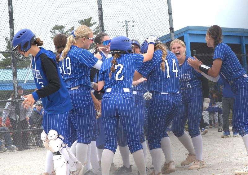 Harper Creek celebrates at home plate after a home run by Allyson Govier during the 2026 All-City Softball Tournament at Bailey Park on Saturday, May 9.