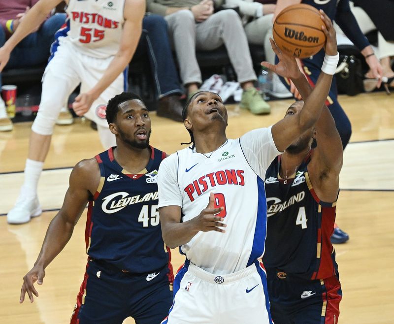 Detroit Pistons guard/forward Ausar Thompson (9) and Cleveland Cavaliers center Evan Mobley (4) battle for a rebound in the second half.
