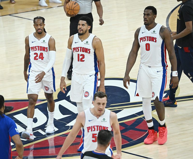 Detroit Pistons guard Daniss Jenkins (24), forward Tobias Harris (12), and center Jalen Duren (0) walk to the bench during a timeout in the first half.