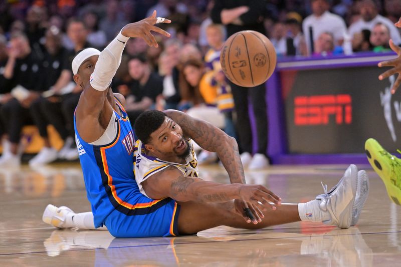Oklahoma City Thunder guard Shai Gilgeous-Alexander (2) and Los Angeles Lakers guard Marcus Smart (36) battle for a loose ball in the first half of Game 3.