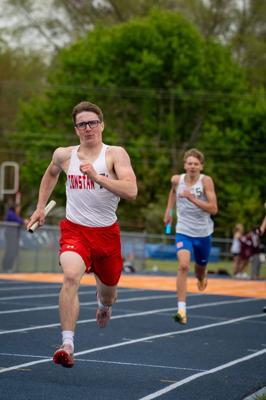 Bear Geibe races to the finish line for Constantine in the mile relay at the league championships.