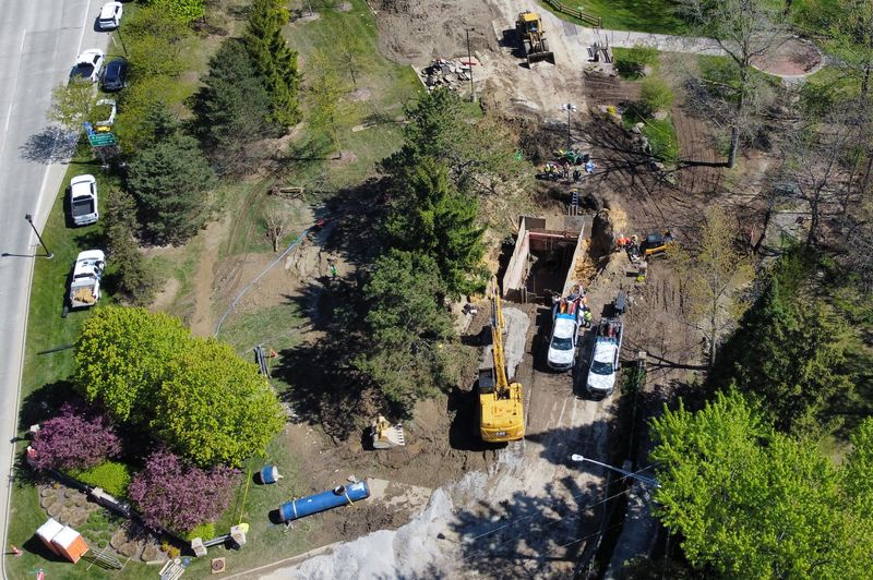 Crews work on a water main break in River Woods Park in Auburn Hills on Monday, May 11, 2026.