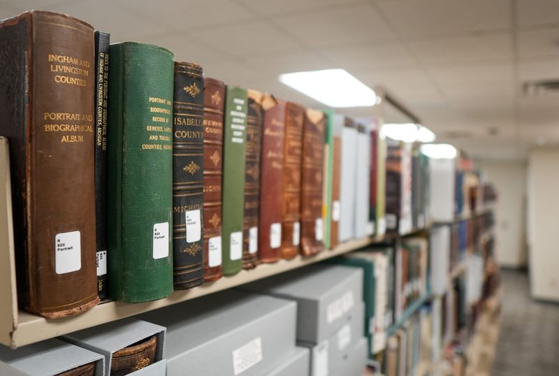 Historical books and other items, seen Monday, May 11, 2026, at the new home of the Capital Area District Library's Local History Center on University Park Drive in Alaiedon Township.