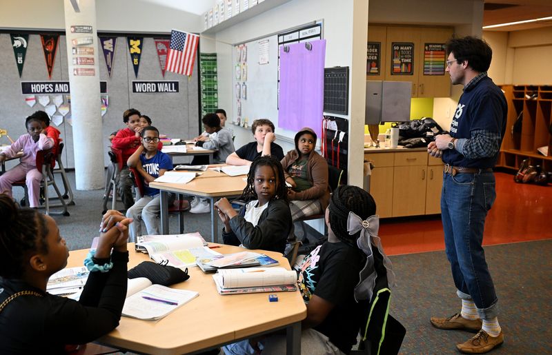 Eli Sparkman, Detroit Program and Volunteer Coordinator for 826michigan, talks with fifth graders on May 5, 2026 at University Preparatory Academy: UPA Elementary School in Detroit. Fifth graders at UPA Elementary published a newspaper, the Detroit Navigator, as a writing project with the non-profit 826michigan.