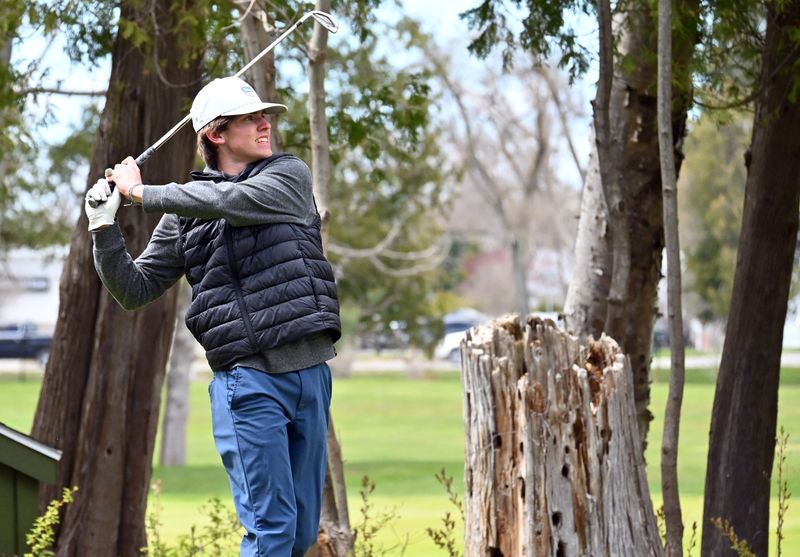 Petoskey senior Madden Pateman watches a tee shot on the back nine of the Petoskey-Bay View Country Club on Monday, May 11 during the annual Petoskey Invitational.