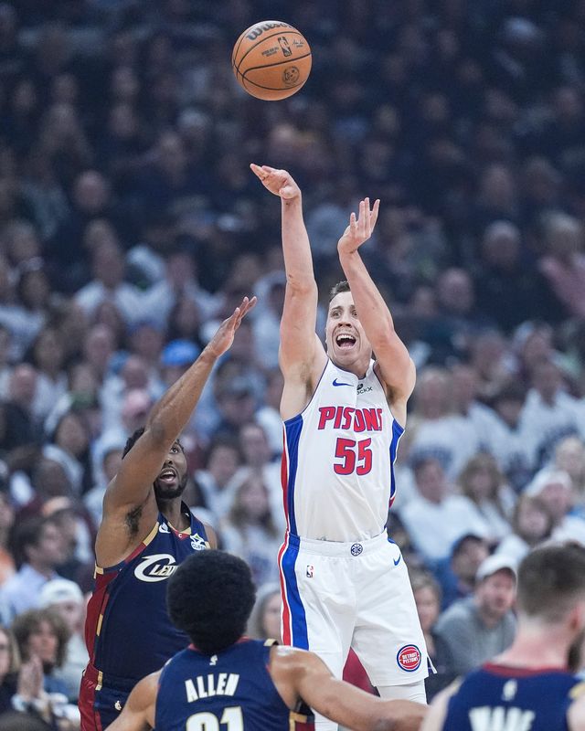 Detroit Pistons forward Duncan Robinson (55) shoots a 3-pointer against Cleveland Cavaliers guard Donovan Mitchell (45) during the first half of Game 4 of second round of NBA playoffs at Rocket Arena in Cleveland on Monday, May 11, 2026.