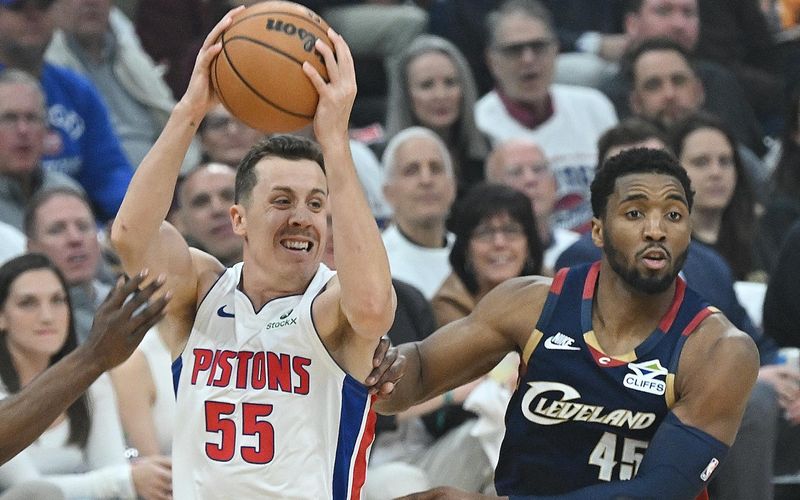 Pistons forward Duncan Robinson, left, is guarded by Cavaliers forward Donovan Mitchell in Game 4 of the Eastern Conference semifinal in Cleveland on Monday.