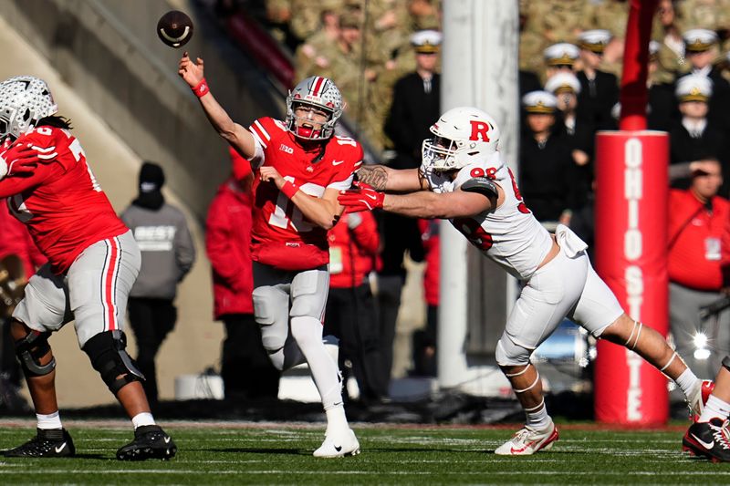 Ohio State Buckeyes quarterback Julian Sayin (10) throws over Rutgers Scarlet Knights defensive lineman Eric O'Neill (99) during the first half of the NCAA football game at Ohio Stadium in Columbus on Nov. 22, 2025.