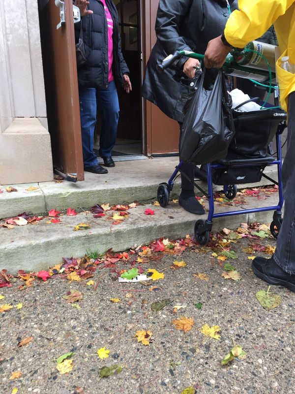 A person using a mobility device struggles to enter a polling location, captured by Detroit Disability Power in 2022.