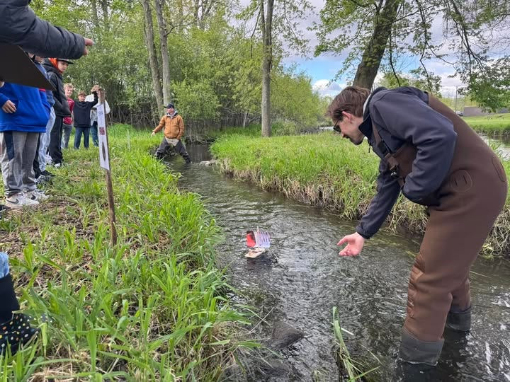 Volunteers man the river as Williams Elementary School's eighth annual boat races commenced May 13.