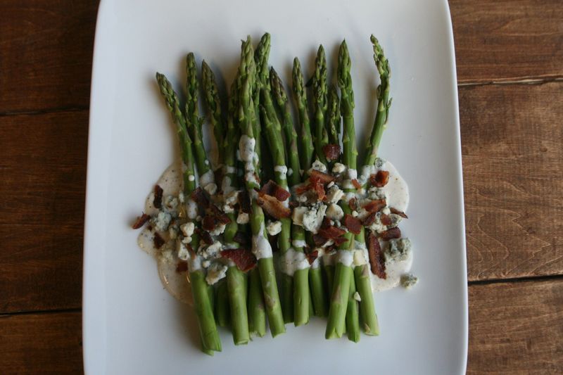 Cooked asparagus topped with crumbled Gorgonzola cheese is a quick and easy side dish.