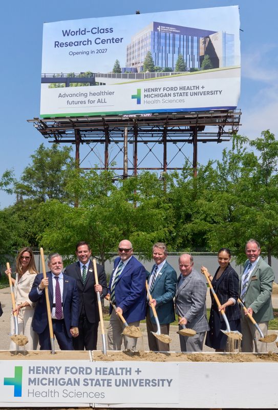 From left to right, Jennifer Gilbert, Dan Gilbert, Dr. Steve Kalkanis, Bob Riney, Kevin Guskiewicz, Mike Duggan, Mary Sheffield and Dan
Kelly attend the FH+MSU Research Building groundbreaking June 17, 2014.