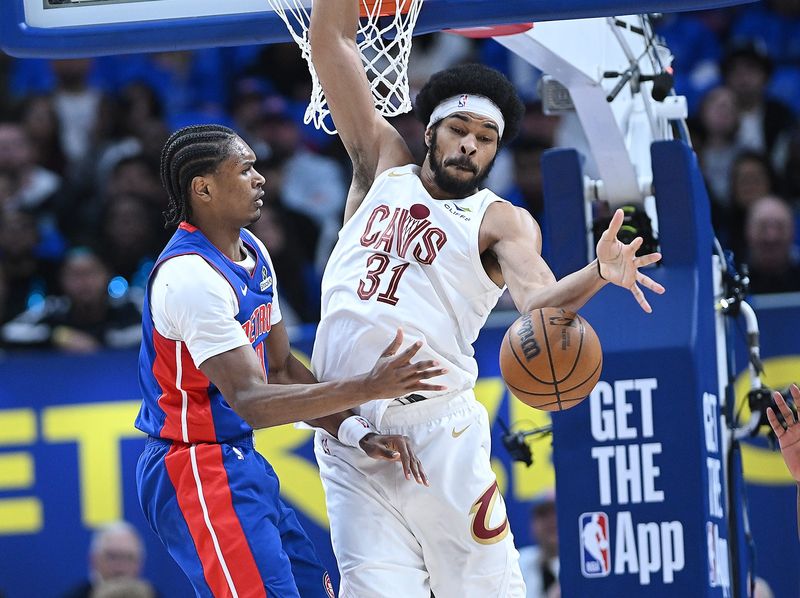 Detroit Pistons guard/forward Ausar Thompson (9) makes a pass over Cleveland Cavaliers center Jarrett Allen (31) in the first half.