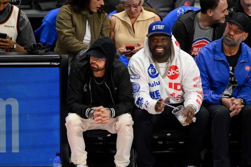 Eminem, left, and 50 Cent watch the game during the first quarter.