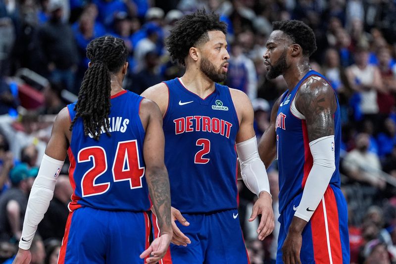 Detroit Pistons guard Cade Cunningham (2) talks to guard Daniss Jenkins (24) and center Paul Reed (7) before a play against the Cleveland Cavaliers during overtime of Game 5 of the second round of the NBA playoffs at Little Caesars Arena in Detroit on Wednesday, May 13, 2026.