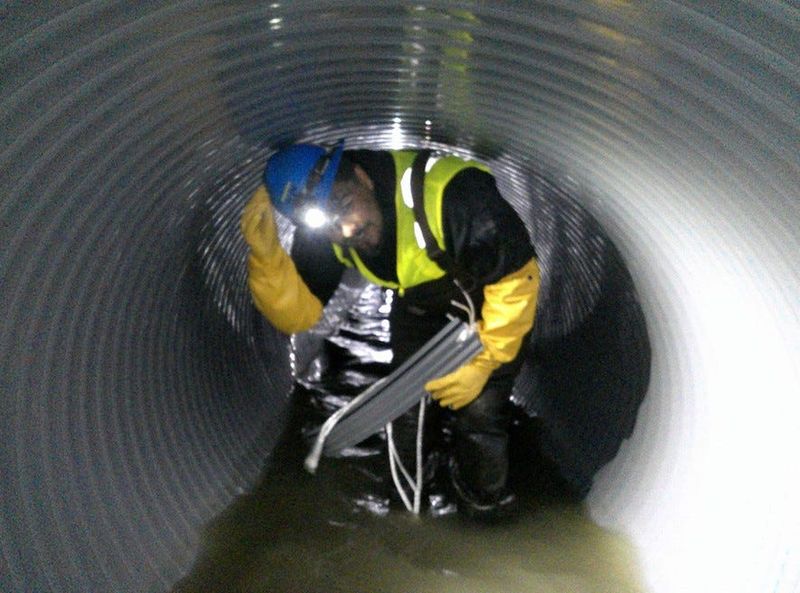 A contractor works inside the 5-foot-diameter, 15 Mile Interceptor sanitary sewer line in Macomb County.