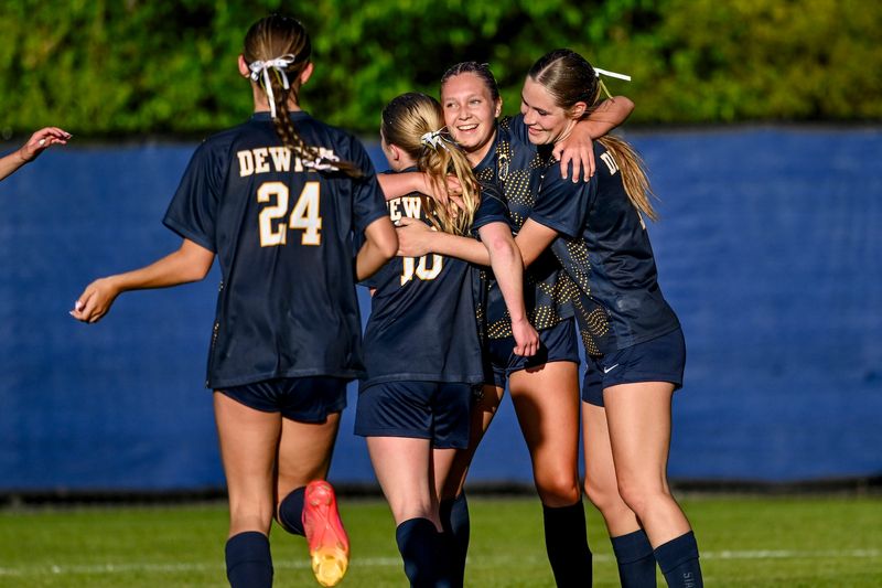 From left, DeWitt's Sailor Stevens, Adaline Bertram, Madison Mccarthy and Ella Rogers celebrate Rogers goal during the first half in the CAAC Gold Cup final against Mason on Thursday, May 14, 2026, in DeWitt.