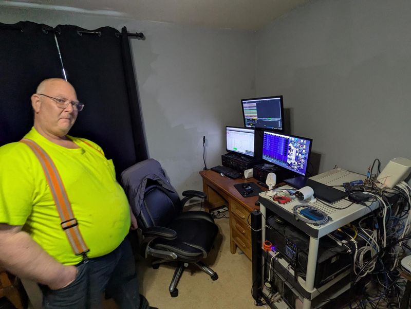 James Jackson at his St. Clair home with his computer and radio setup.
