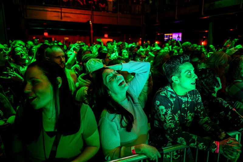 Bethany Vermette, 49, center, sings along as country singer Lily Rose performs on Thursday, May 14, 2026 at District 142, a music venue in downtown Wyandotte, Mich.