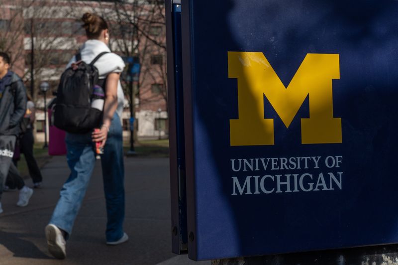 People walk near The Diag on the University of Michigan campus in Ann Arbor on Friday, March 28, 2025.