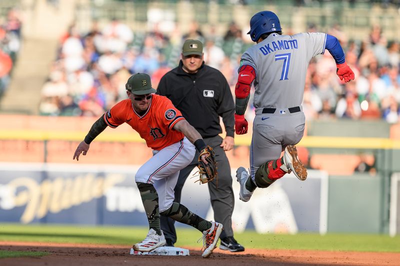 Toronto Blue Jays third baseman Kazuma Okamoto (7) leaps into second base to avoid the tag from Detroit Tigers shortstop Kevin McGonigle (7) for a double in the second inning May 15, 2026 at Comerica Park.
