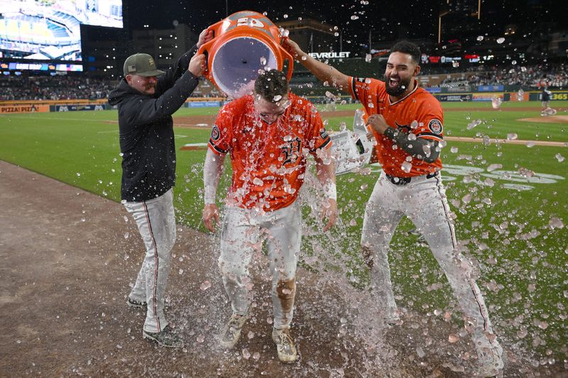 May 15, 2026; Detroit, Michigan, USA; Detroit Tigers first baseman Spencer Torkelson (20) gets doused with water by teammates Riley Greene (right) and Jake Rogers (34) after hitting a walk-off RBI double against the Toronto Blue Jays in the ninth inning at Comerica Park. Mandatory Credit: Lon Horwedel-Imagn Images