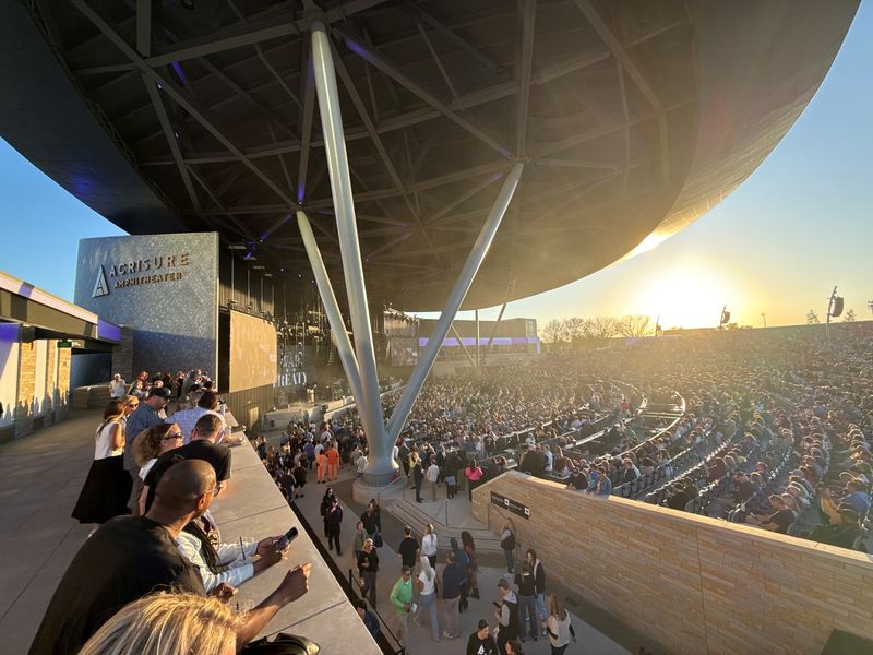 Fans gather along the railing stage right of the venue at the opening night of Grand Rapids' Acrisure Amphitheater on May 15, 2026.