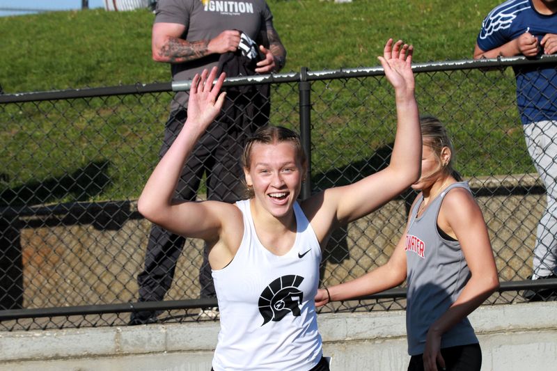 Sydney Bir reacts after her time was posted on the video board in the 400 run on Friday at regionals.