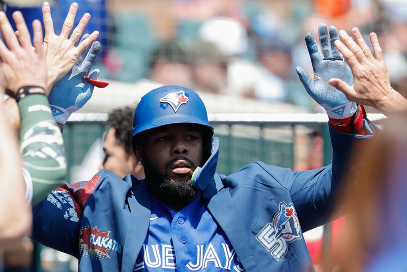 Toronto Blue Jays first baseman Vladimir Guerrero Jr. (27) receives congratulations from teammates after he hits a home run in the first inning against the Detroit Tigers at Comerica Park in Detroit on Sunday, May 17, 2026.